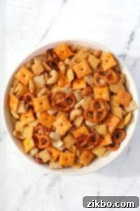 A bowl of Chex Mix on a white background.