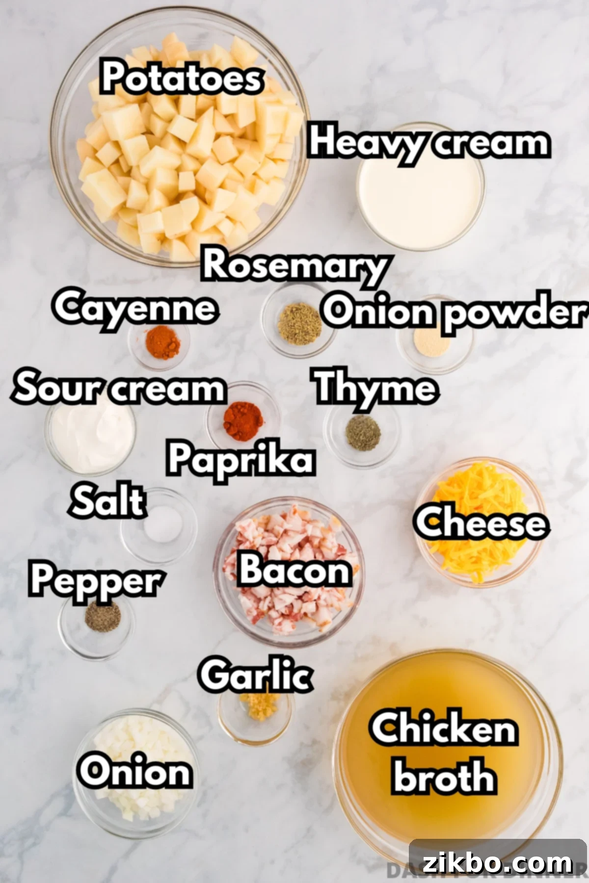 A collection of fresh ingredients laid out on a wooden board, including russet potatoes, bacon, onions, garlic, and various seasonings, ready for making loaded baked potato soup.
