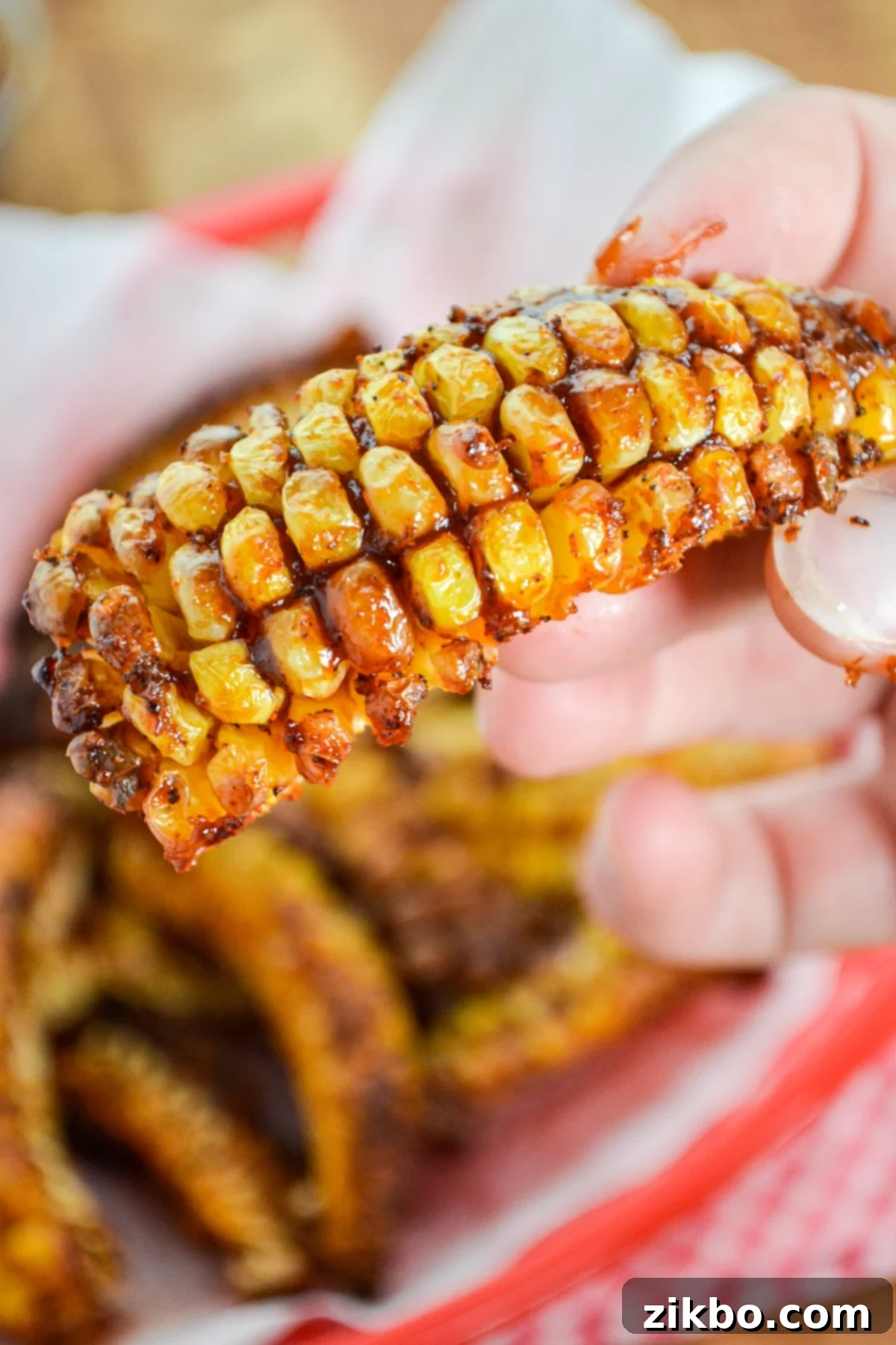 Corn ribs, covered in barbeque sauce, ready to be enjoyed as a snack or side dish, emphasizing crispiness.