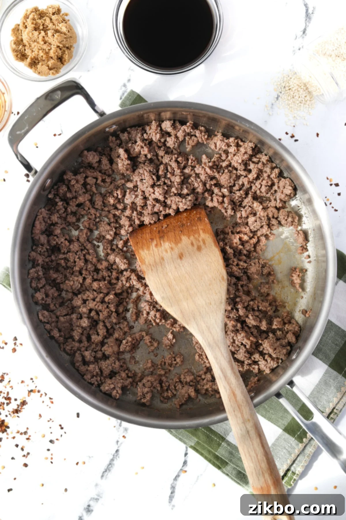Ground beef browning in a large, heavy-bottomed skillet over medium heat.
