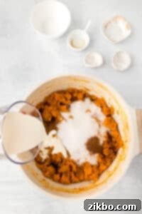 A pot of mashed sweet potatoes with sugar, cinnamon, and cream added.