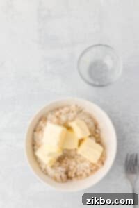 A small bowl of flour and brown sugar with butter added.