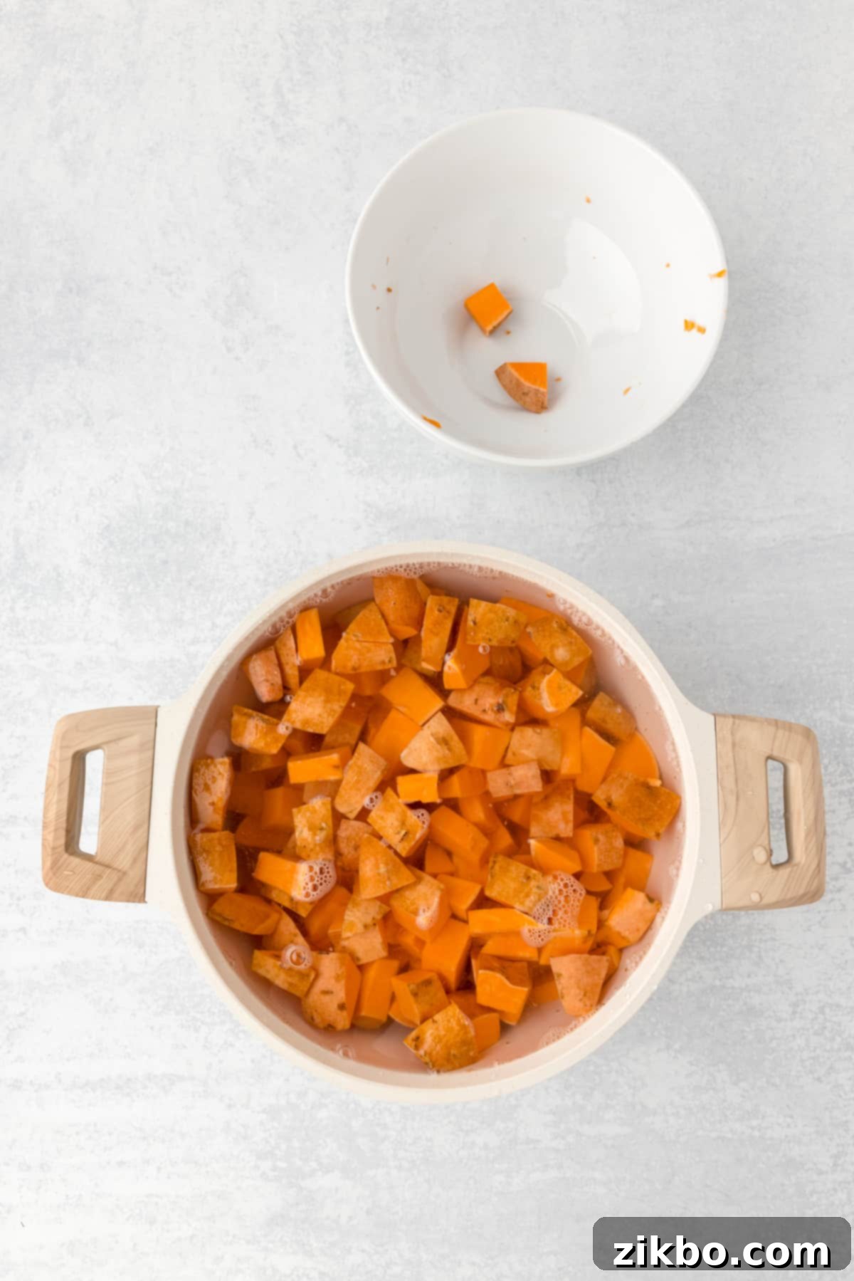 A pot filled with water and sweet potato cubes, ready to boil.