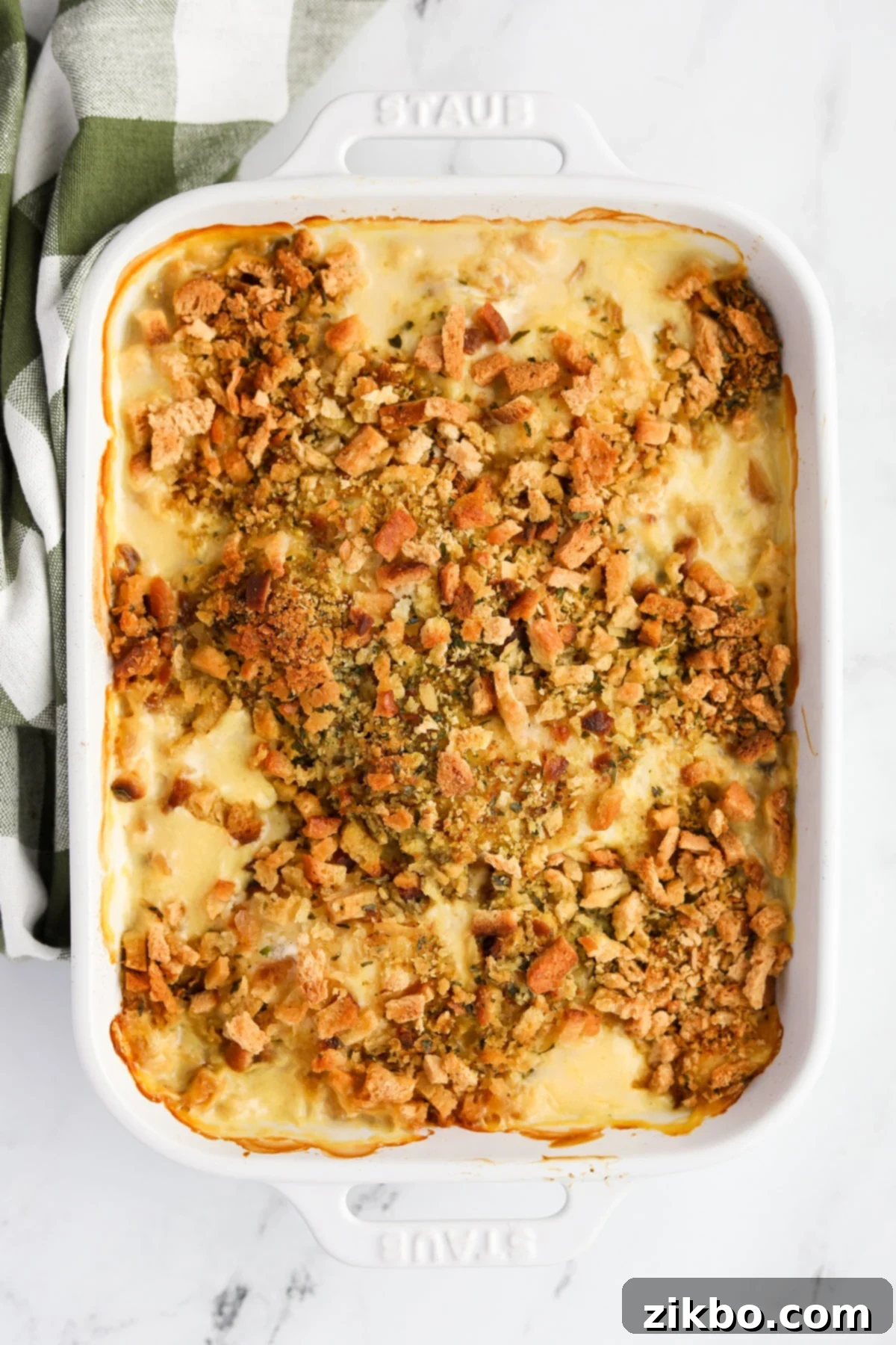 A baking dish filled with a bubbling chicken and stuffing casserole, freshly out of the oven.