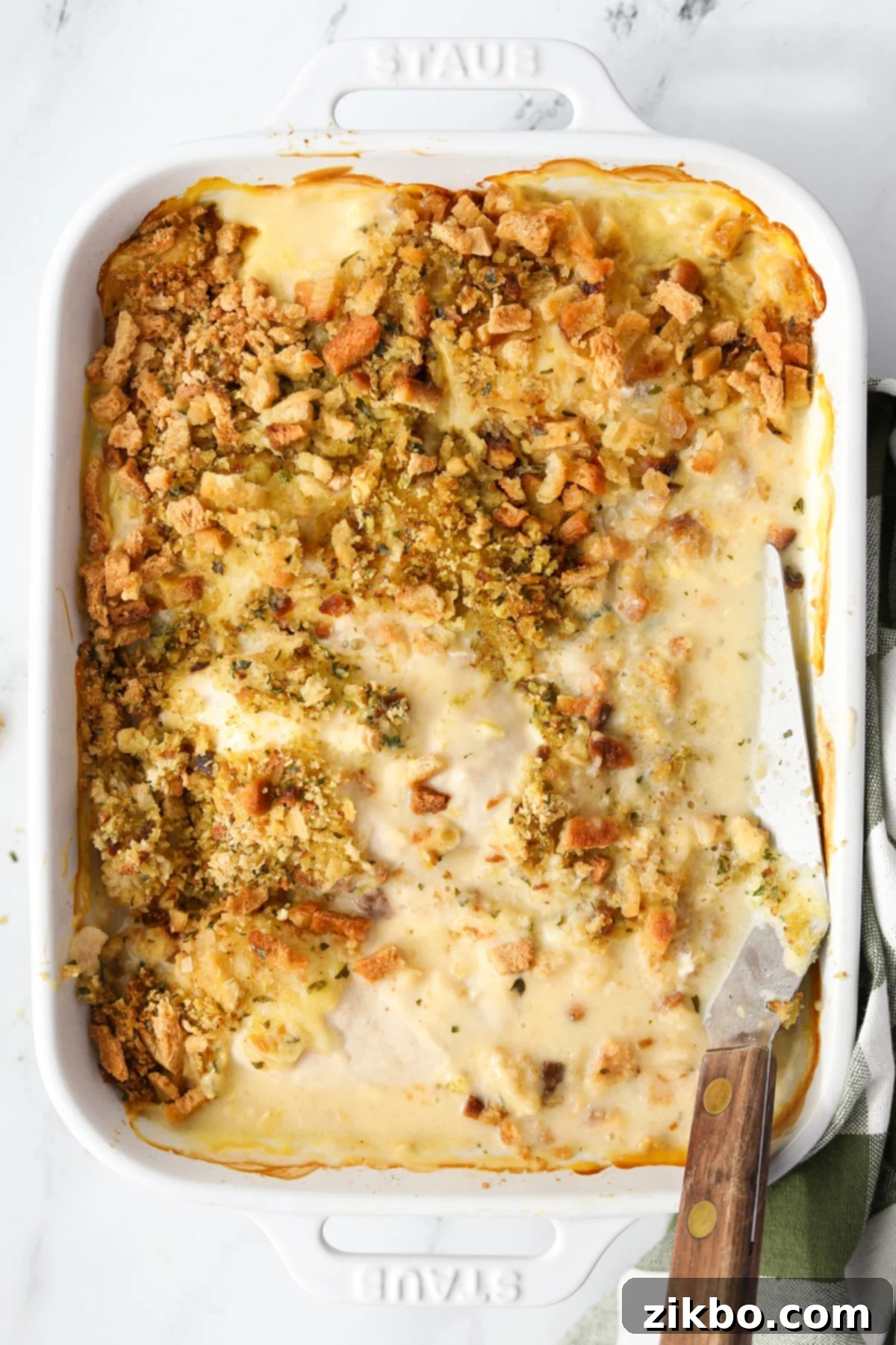 A large baking dish of Swiss Chicken Casserole, ready to be served, showing the golden-brown stuffing.