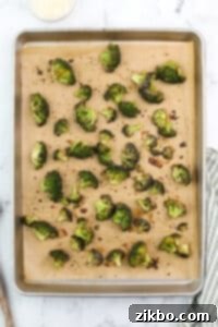 Roasted broccoli on a baking sheet.