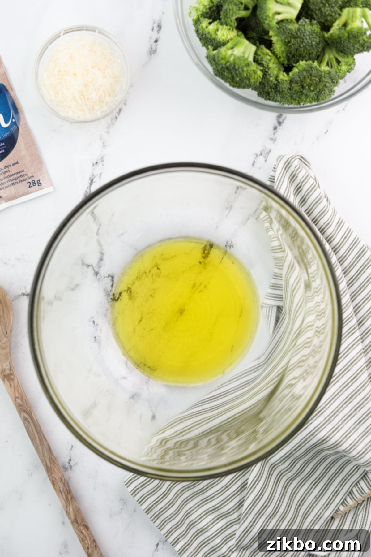 A mixing bowl with golden olive oil, ready for the seasoning.
