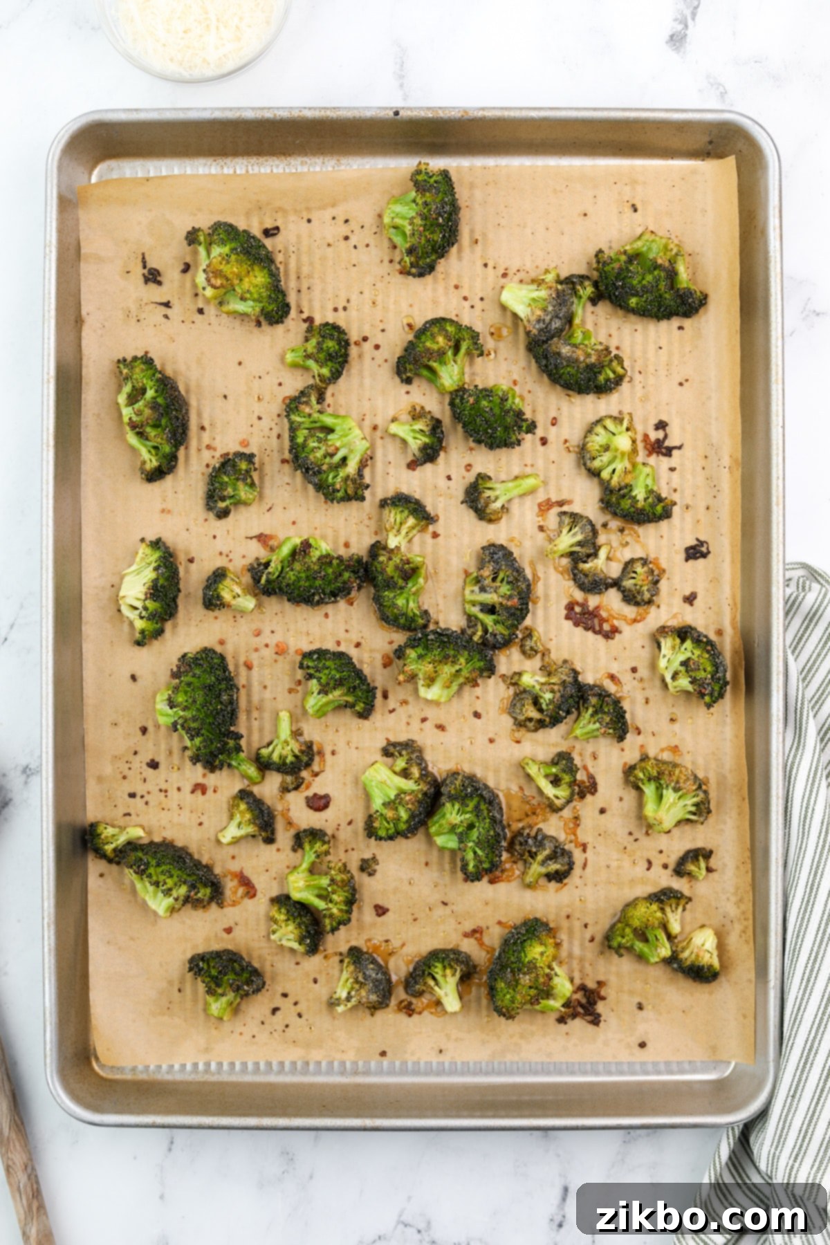 A baking sheet filled with perfectly golden brown and tender-crisp roasted ranch broccoli, fresh from the oven.