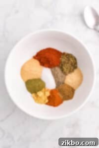 A small bowl featuring various spices, seasonings, salt, etc.