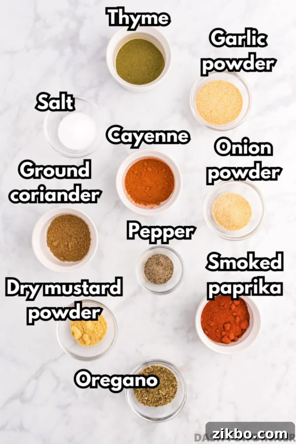 Small bowls of various seasonings, including cayenne, pepper, garlic powder, onion powder, etc.