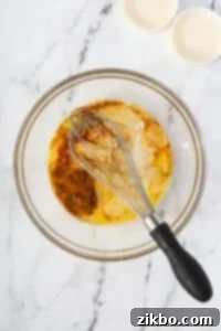 A bowl of eggs and heavy cream with vanilla and cinnamon added.