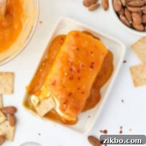 Spicy Southern Jezebel Dip 12 Hot Jezebel Dip served with crackers on a white plate