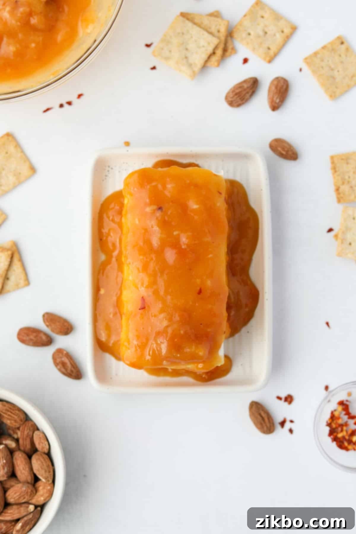 Spicy Southern Jezebel Dip 9 Step 6: Pouring the Hot Jezebel sauce generously over the softened cream cheese block