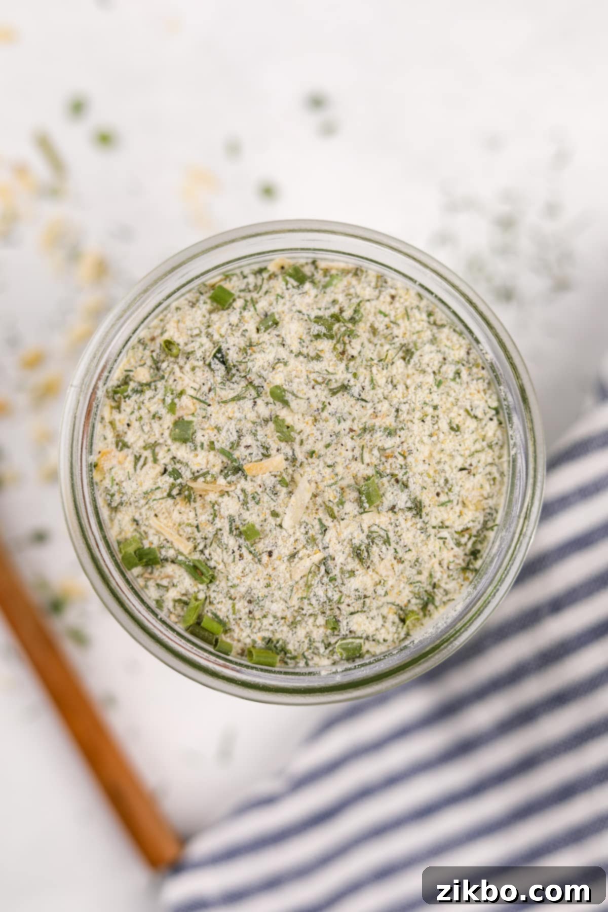 A small glass jar filled with the homemade dry ranch mix, labeled and ready for storage or immediate use.