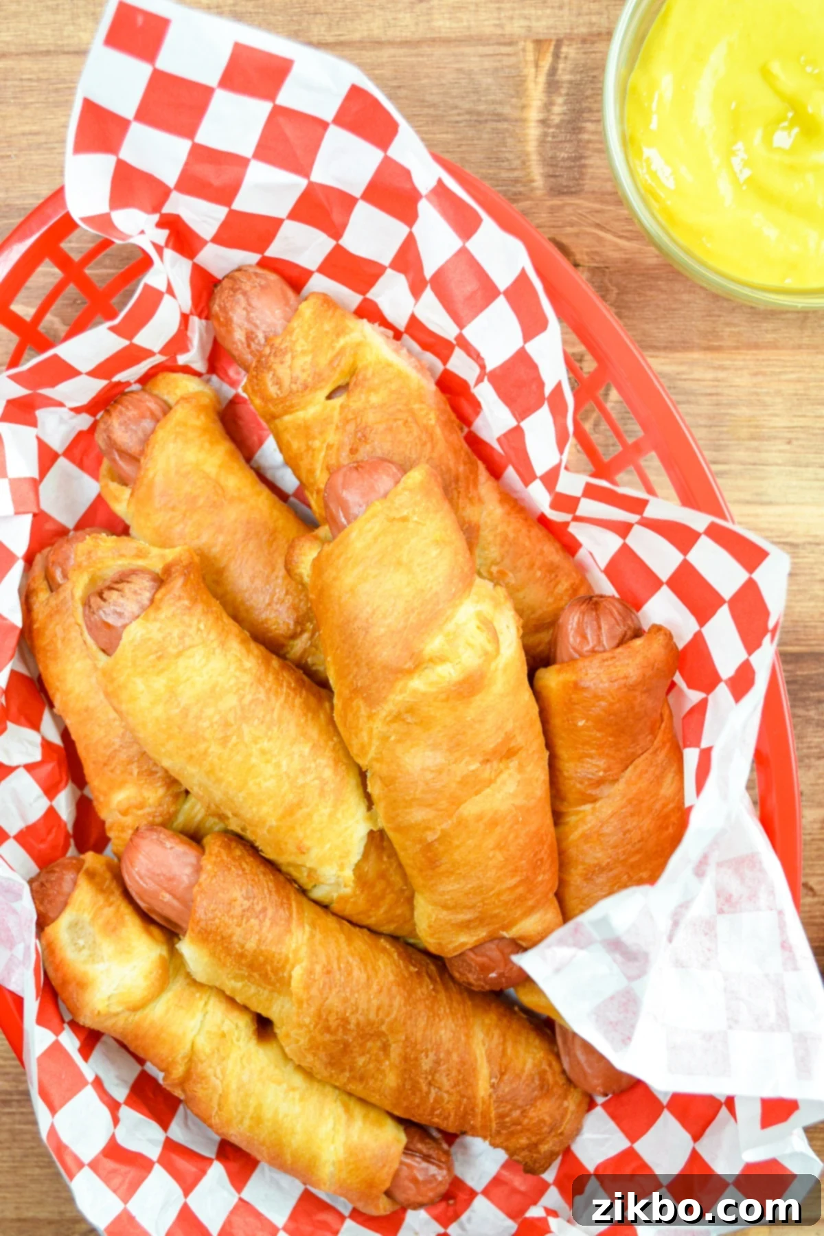 Crispy Air Fryer Pigs in a Blanket 2 Freshly cooked Air Fryer Pigs in a Blanket, golden brown and ready to eat.
