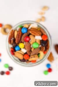 An overhead view of a mason jar filled with trail mix.