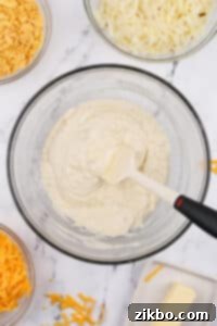 A large bowl with a creamy sauce in it.